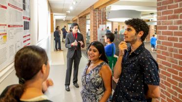 Students talk during a poster session.