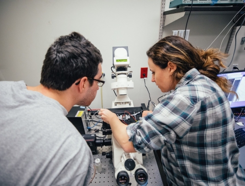 MCB student Lauren Panzera (Hoppa Lab) showing off a microscope