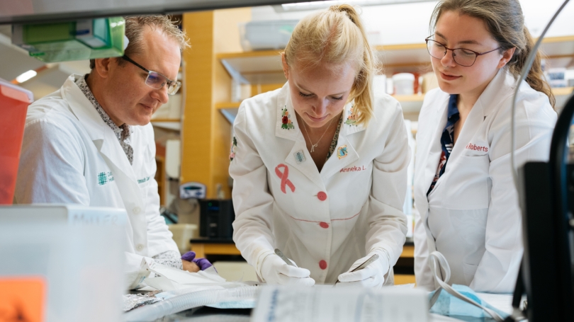 Assoc. Professor of Molecular and Systems Biology Todd Miller (left) working with MCB grad students Anneka Johnson and Alyssa Roberts