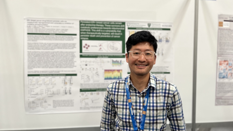 Steven Tau in front of his research poster