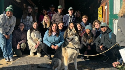  South House community members with a wolf during a trip to a wolf dog sanctuary, The Farm at Sakari's Place. 