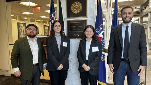 four graduate students in formal attire