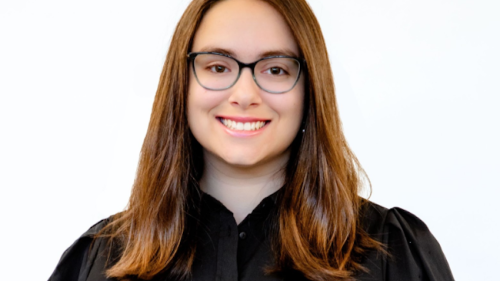 A woman in glasses smiling