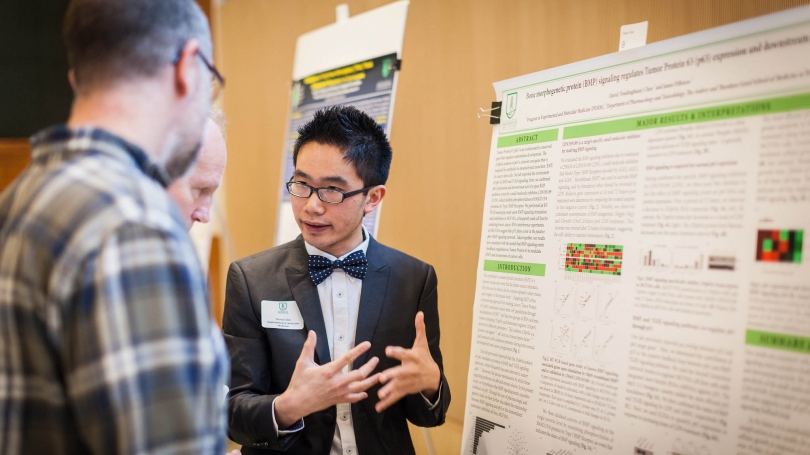 David Chen, a graduate student, discusses his research at a recent poster session 