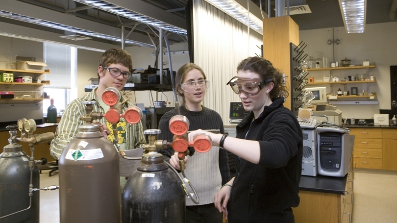 Three graduate students in a chemistry lab in Burke Hall