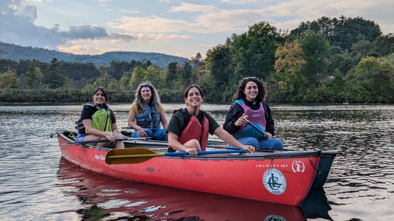 Four postdocs canoeing on the river during postdoc appreciation week