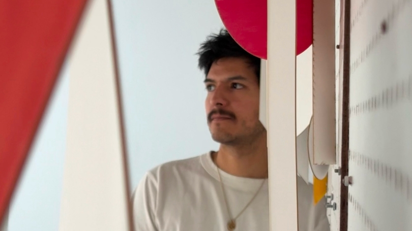 A man standing in a brightly colored art installation