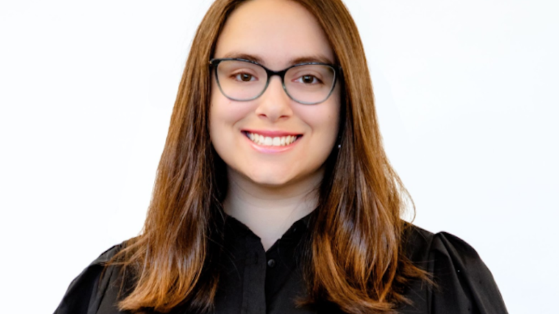 A woman in glasses smiling
