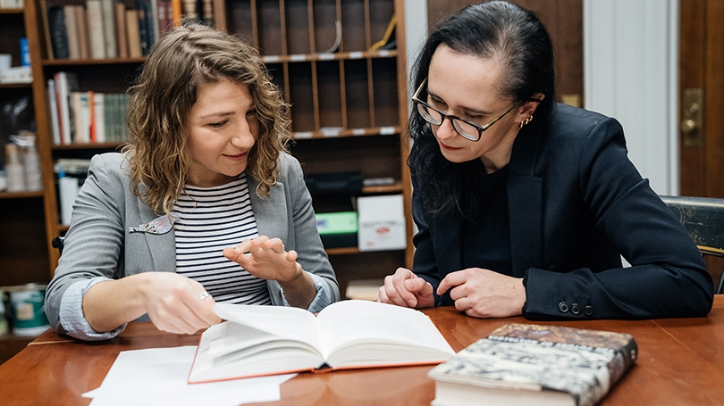 Tetiana Savchynska (left) confers with her adviser, Yuliya Komska, an associate professor of German.