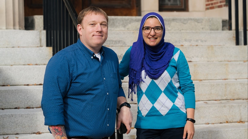 Gary Sund, left, and Sophia Brelvi stand in front of an unnamed building on campus.