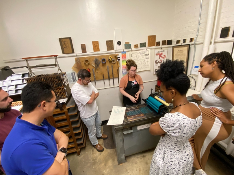 Postdocs at a demonstration on letterpress printing