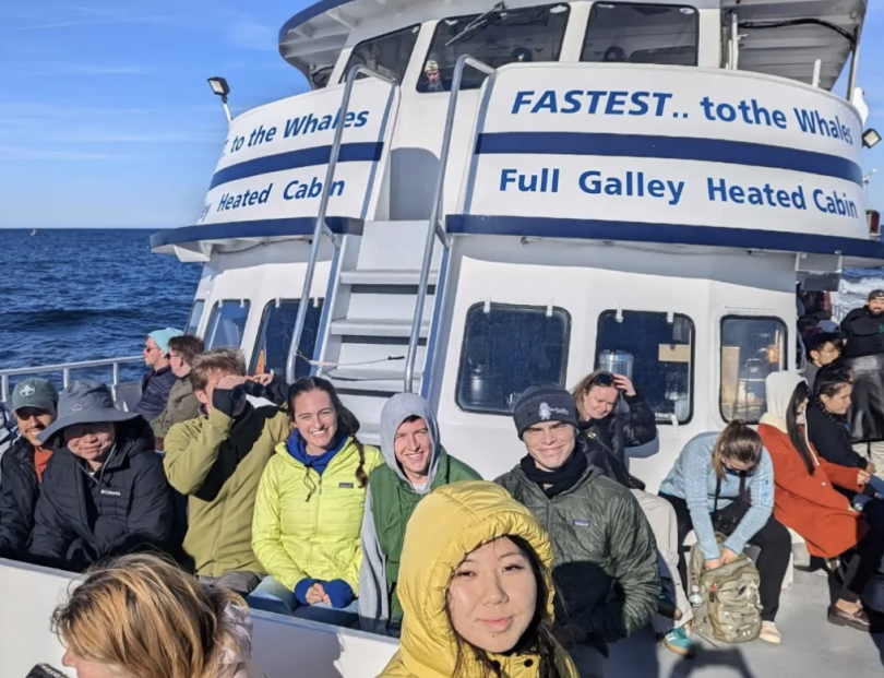 Members of a house community on a whale watching trip.